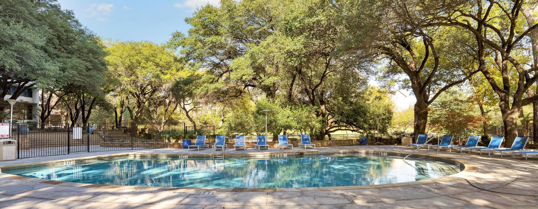 a pool with chairs around it