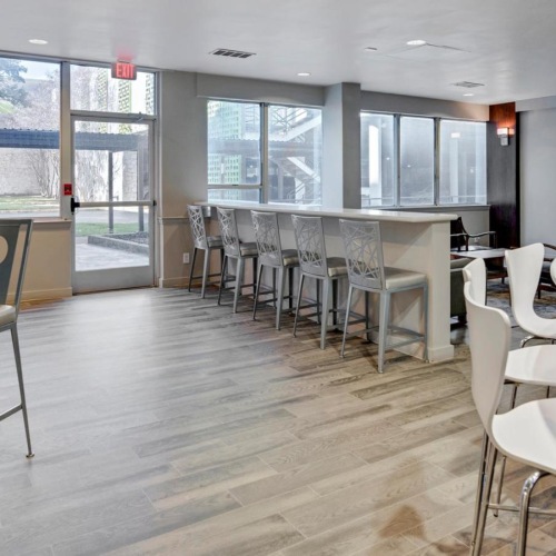 Get ready for social comfort in our lounge area a room with tables and chairs