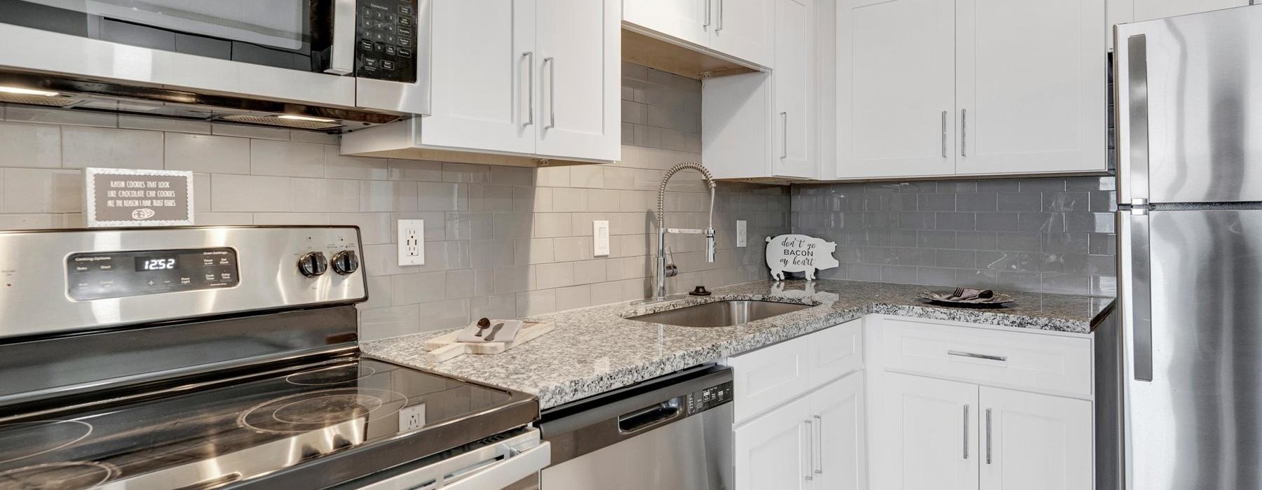 a kitchen with white cabinets