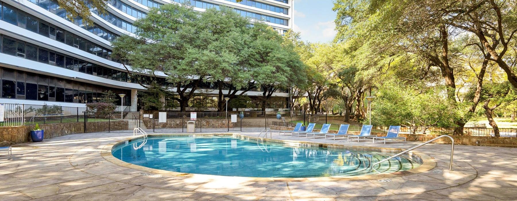 a large swimming pool in front of a building