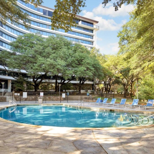 Soak up the sun at our resort-style pool a large swimming pool in front of a building