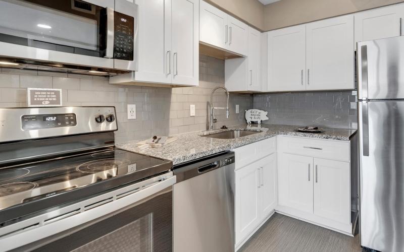 a kitchen with white cabinets